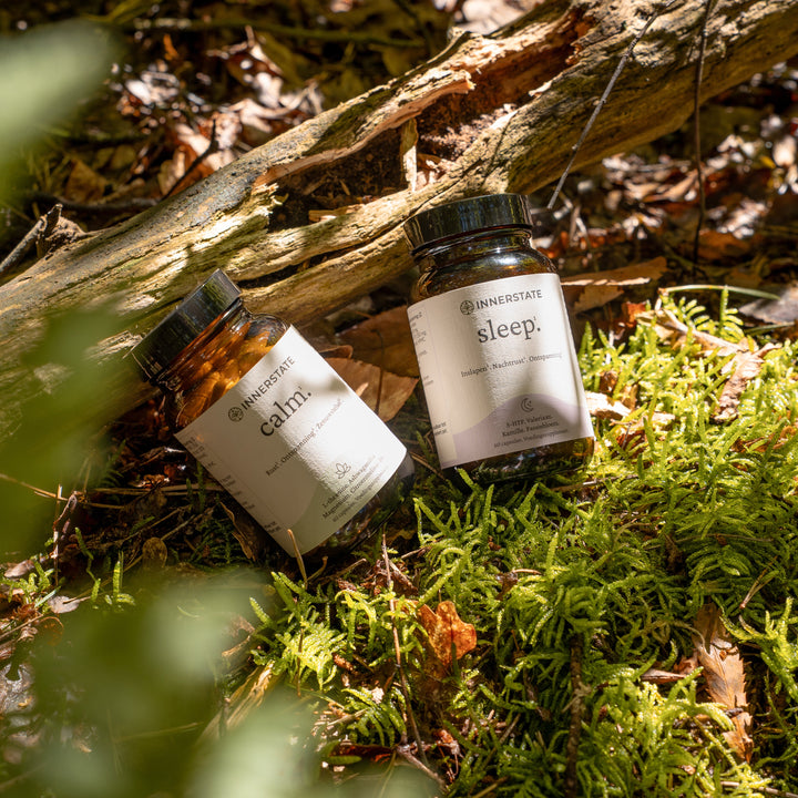 Calm en sleep supplementen uit de Innerstate Ontspan bundel tussen mos in het bos voor natuurlijke rust en nachtrust